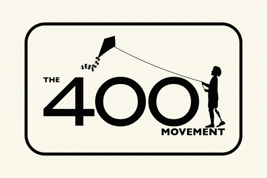 A beige box with an outline in black. Inside the black outline are the words "The 400 Movement". On top of the word movement is the image of little kid flying a kite.